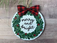 a christmas ornament hanging on a wooden wall with the words merry and bright