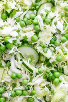 peas, cucumbers and shredded cabbage are mixed together in a large salad bowl