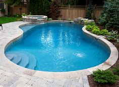 a small pool in the middle of a backyard