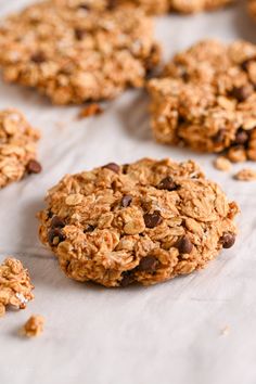 chocolate chip oatmeal cookies sitting on top of a white sheet of paper