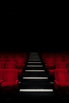 rows of red seats in an empty theater