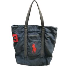 a black tote bag with a red polo logo on the front and two handles