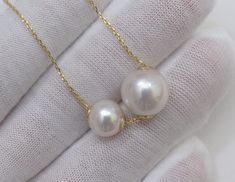 Material : Two Genuine Natural Edison White Round Pearls with 925 Sterling Gold Chain Quantity : One Necklace with Chain Shape : Round Pearls Pearl Size : Large Pearl is 10-10.5mm & Small Pearl is 7-7.5mm approx. Color : Natural White Edison Pearls on 925 Sterling Gold Chain Length : 16-18 inch approx. (Chain is adjustable) ** If you need shorter or longer chain, or have any question, please feel free to convo us, thank you for shopping with us ** Lead Time & Shipping : This is an order White Pendant Necklace With Bail, Round White Necklace With Bail, White Double Strand Jewelry For Anniversary, White Sterling Silver Double Strand Jewelry, White Jewelry With Bail For Gift, White Wedding Necklace, Floating Pearl Necklace, Gold Star Pendant, Genuine Pearl Necklace