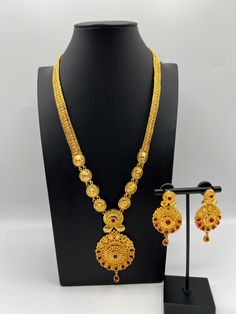 Embrace regal elegance with our exquisite 24K gold-plated Rani Haar set, a true masterpiece designed for the modern queen. This luxurious jewelry set, inspired by traditional royal designs, is perfect for weddings, special occasions, or adding a touch of grandeur to your collection. Care Instructions: To maintain the pristine condition of your Rani Haar set, avoid direct contact with water, perfumes, and harsh chemicals. Store in a dry, cool place when not in use. Luxury Fusion Temple Necklace For Celebration, Luxury Gold Plated Temple Necklace For Ceremonial Occasions, Luxury Fusion Temple Necklace Gift, Rani Haar Gold Design, Luxury Fusion Temple Necklace As Gift, Luxury Fusion Temple Necklace For Ceremonial Occasions, Rani Haar Gold Indian Bridal, Luxury Fusion Temple Necklace For Gift, Luxury Temple Jewelry Tikka As Gift