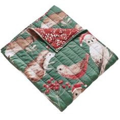 a green and red quilted placemat with birds on it