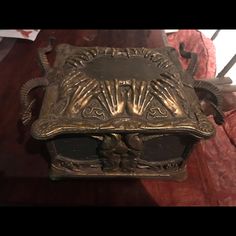 an antique brass clock on a wooden table