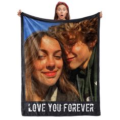 two young women are holding up a black blanket with the words love you forever on it