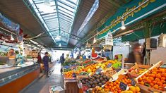 an outdoor market with lots of fruits and vegetables