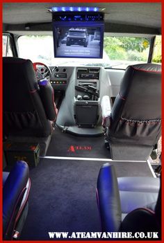 the interior of a vehicle with black leather seats and red stitching on the floor