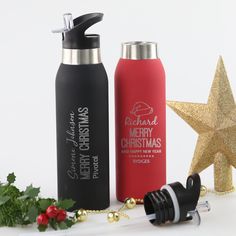 two personalized christmas water bottles next to a star