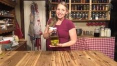 a woman standing in front of a wooden table