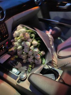 a bouquet of flowers is sitting in the driver's seat of a car