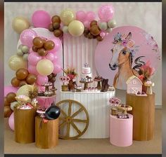 a horse themed birthday party with balloons and desserts