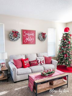 a living room decorated for christmas with red and white decorations