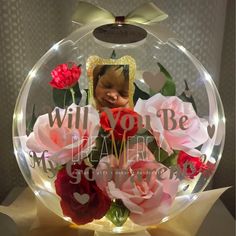 there is a glass ball with roses in it that says, will you be my valentine?