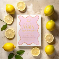 a pink and yellow wedding card surrounded by lemons