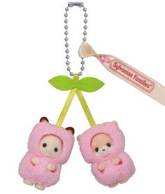 two small stuffed animals hanging from a key chain