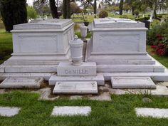 the headstones of two large and small tombstones are shown in this cemetery setting