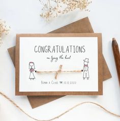 congratulations card for the bride and groom on top of a table next to some flowers