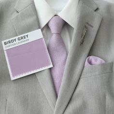 a close up of a person wearing a suit and tie with a label on it