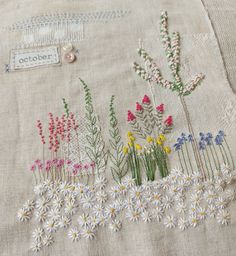 a close up of a piece of cloth with flowers on it and a button in the middle