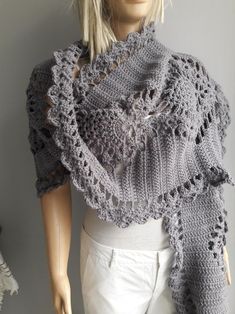 a mannequin wearing a gray crocheted shawl