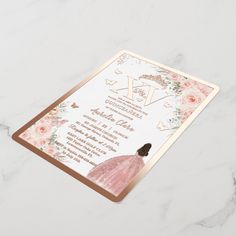 a wedding card with pink flowers and gold foil on the front, featuring an image of a woman in a dress