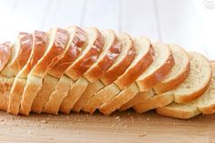 sliced bread sitting on top of a wooden cutting board