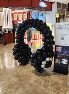 a large balloon wreath in the middle of a mall