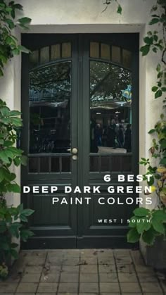 the front door to a building with green doors and plants growing on it's sides