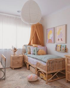 a bedroom with a bed, dresser and table in it