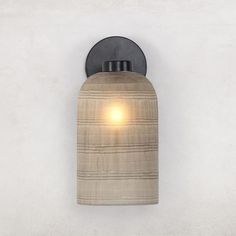 a light that is on the side of a wall in a room with white walls