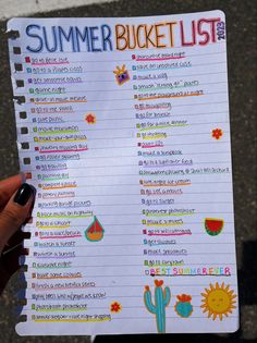 a person holding up a summer bucket list