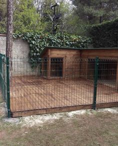 a wooden dog house in the middle of a yard