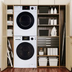 a washer and dryer sitting in a closet next to each other on top of a hard wood floor