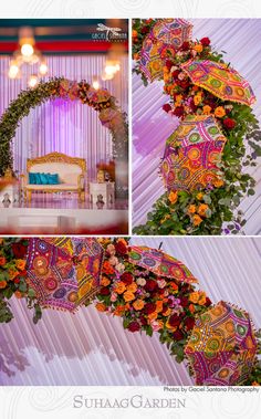 an arrangement of flowers and umbrellas in front of a purple backdrop at a wedding