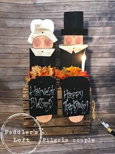 two wooden pallets decorated with halloween decorations and writing on them, sitting next to each other