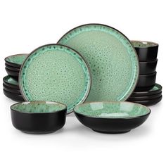 green and black dinnerware set on white background