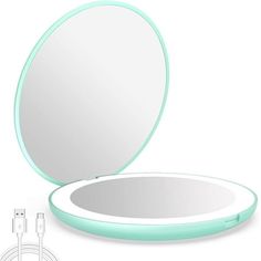 an image of a round mirror with light blue trimmings and plugged in