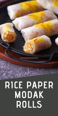 rice paper modak rolls on a black plate with text overlay reading rice paper modak rolls