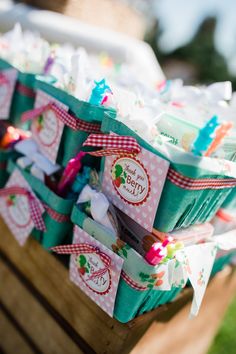 baskets filled with candy sitting on top of a wooden table