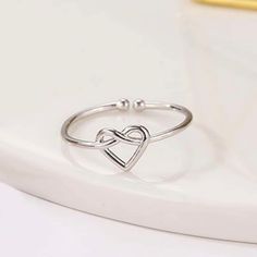 Knotted Heart Ring About A Size 7 -Silver ****Colors May Vary In Person From How They Are Pictured Due To Lighting**** Pet Friendly Home Smoke Free Home Adjustable Silver Heart Ring For Mother's Day, Dainty Silver Heart Ring For Mother's Day, Silver Open Heart Ring, Black Sapphire Ring, Sunburst Ring, Luxury Wedding Rings, Big Stone Ring, Charm Ring, Pear Ring