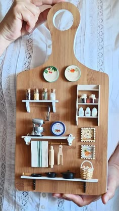 a person holding a wooden tray with various items on it