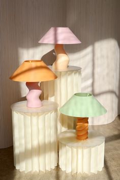 three different colored lamps sitting next to each other