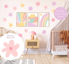 a baby's room with pink and yellow flowers on the wall