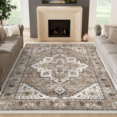 a living room area with couches and a rug on the floor in front of a fireplace