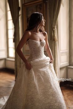 a woman in a wedding dress is posing for the camera