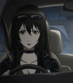 a woman sitting in the driver's seat of a car with long black hair