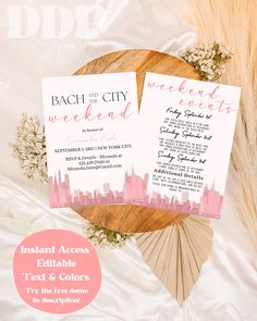 two pink and white city skylines are on top of a wooden plate with flowers