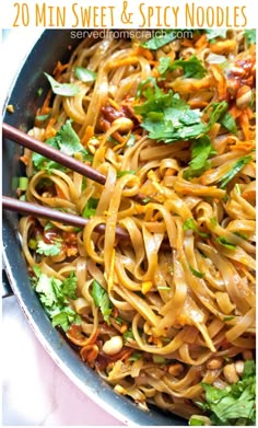 a pan filled with noodles and vegetables on top of a table